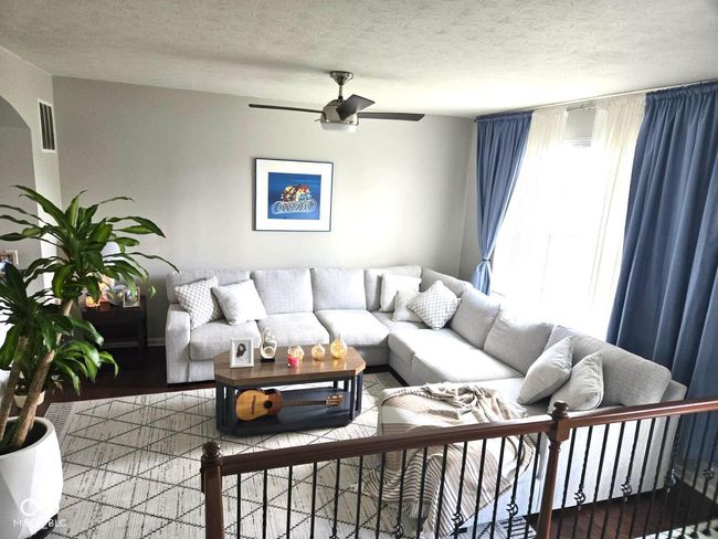 living area with a ceiling fan and a textured ceiling | Image 5