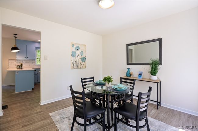 Dining area featuring baseboards and dark wood finished floors | Image 13