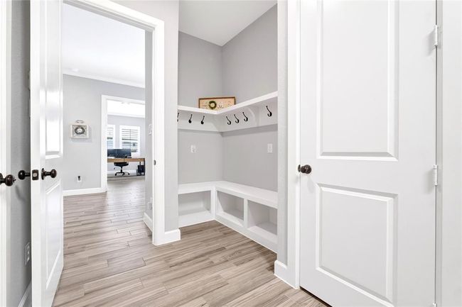 Massive laundry space with storage bench and plenty of hooks for hanging items. Extra storage closet! | Image 36