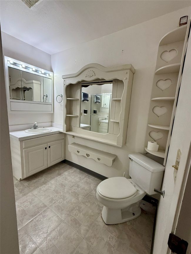 Bathroom featuring toilet and vanity | Image 12