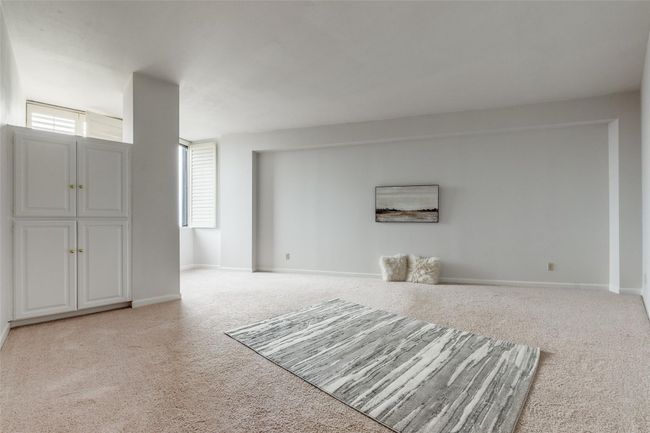 Unfurnished living room with light colored carpet and baseboards | Image 5