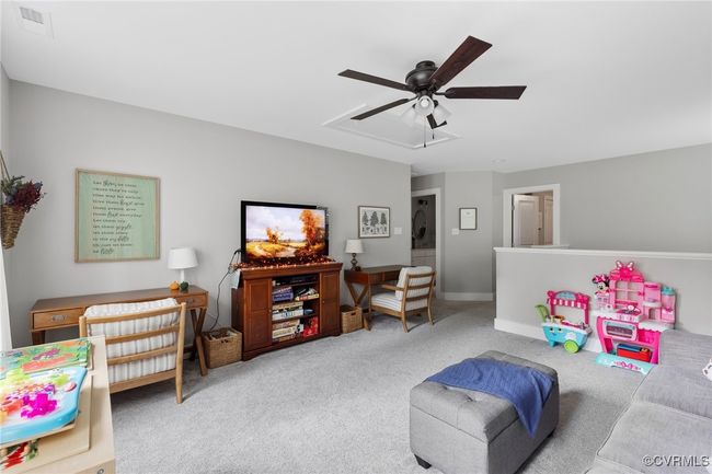 Rec room featuring carpet floors, baseboards, ceiling fan, and visible vents | Image 23