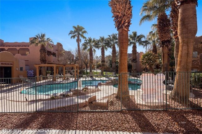 Pool featuring fence and a patio area | Image 49