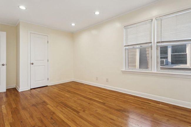 Unfurnished room with hardwood / wood-style flooring, baseboards, ornamental molding, and recessed lighting | Image 16