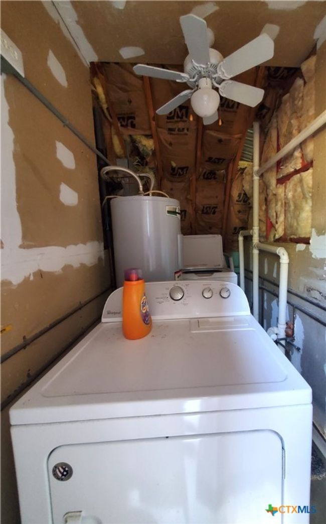 Laundry area is outside of living area, but inside of the garage just past front entry. | Image 19