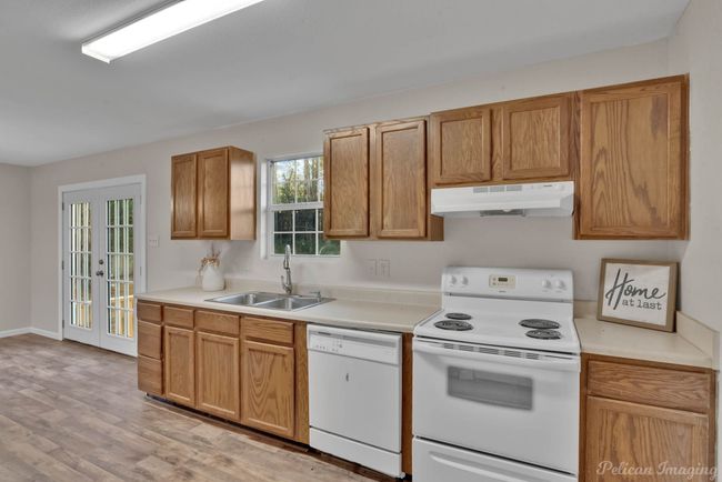 Kitchen featuring french doors, light hardwood / wood-style floors, white appliances, and sink | Image 10