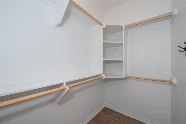 Spacious closet with wood finished floors | Image 8