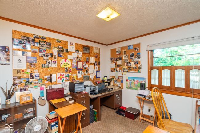office space with crown molding, carpet, and a textured ceiling | Image 19