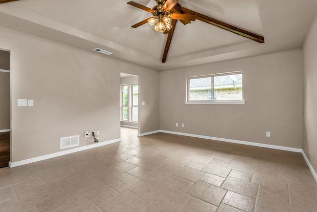 Empty room with healthy amount of natural light and a ceiling fan | Image 15