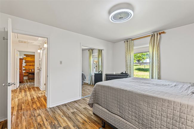Bedroom featuring attic access, wood finished floors, and a closet | Image 19