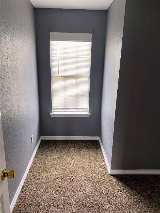Carpeted spare room featuring baseboards and a textured wall | Image 16