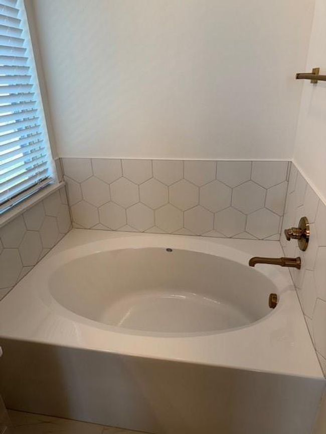 Bathroom featuring a bath | Image 23