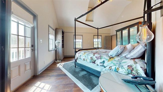 Bedroom with high vaulted ceiling and hardwood / wood-style floors | Image 22