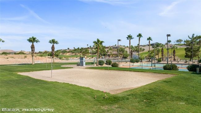 View of property's community featuring a lawn, fence, volleyball court, and a tennis court | Image 67