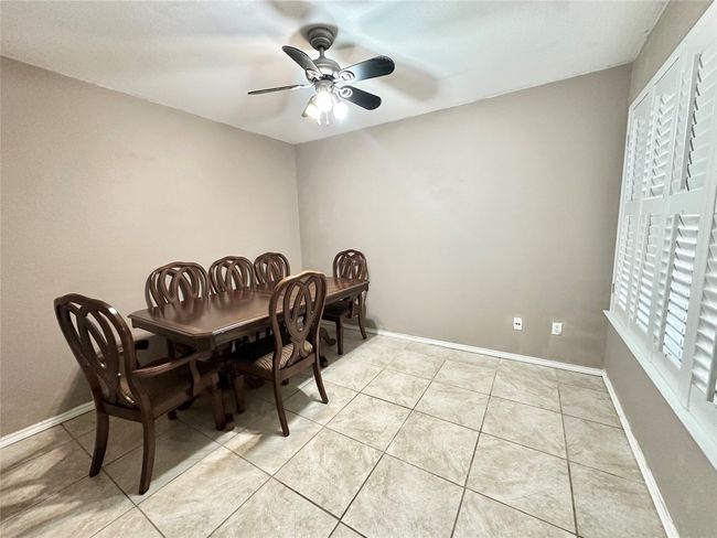 Dining area featuring ceiling fan and light tile patterned flooring | Image 4