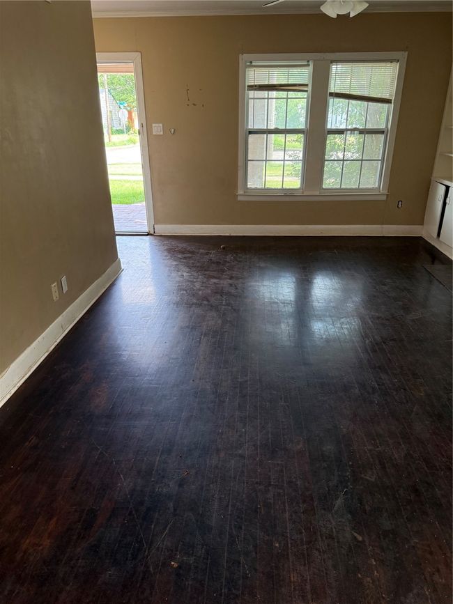 Empty room with dark wood finished floors, ornamental molding, and ceiling fan | Image 4