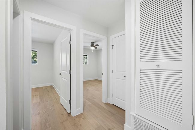 Hallway featuring light wood finished floors and plenty of natural light | Image 24