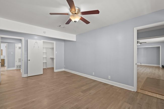 Unfurnished bedroom featuring light wood finished floors, visible vents, and baseboards | Image 23