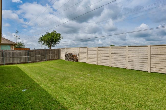 View of fenced backyard | Image 37