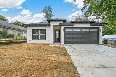 Prairie-style home featuring a garage and a front lawn | Image 1