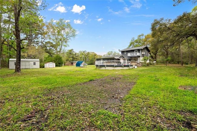 Backyard with a pool. | Image 19