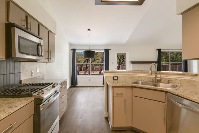 The kitchen offers a direct line of sight to the dining and living areas for entertaining. | Image 7