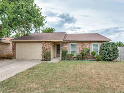 Single story home featuring a garage and a front lawn | Image 1