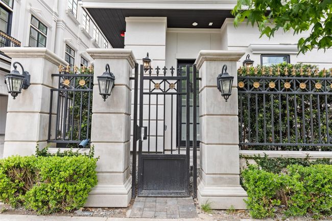 The home's private access gate with keypad entry ensures security and peace of mind, welcoming guests with convenience and control. | Image 43