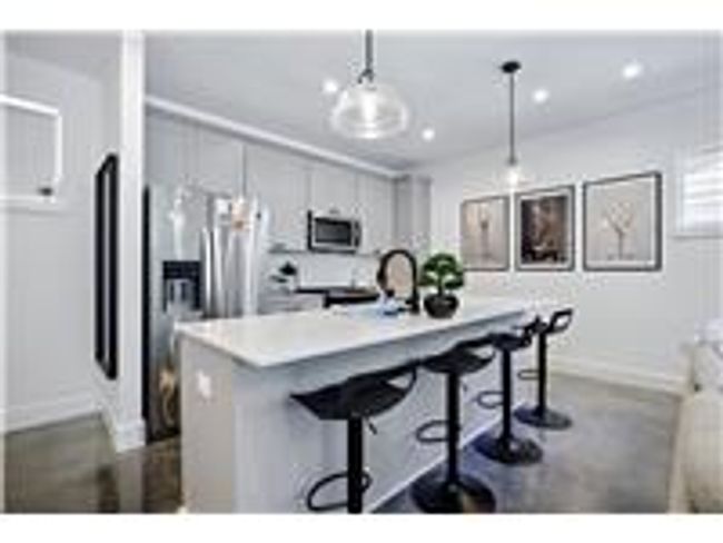 Kitchen featuring light stone countertops, backsplash, pendant lighting | Image 13