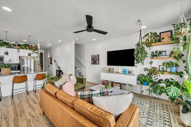 Living room with stairs, a ceiling fan, recessed lighting, and light wood-type flooring | Image 8