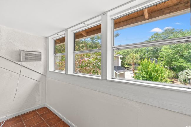 Unfurnished sunroom featuring healthy amount of natural light and a wall mounted AC | Image 21