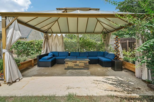 View of patio / terrace with an outdoor living space with a fire pit and a gazebo | Image 29