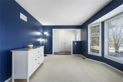 Unfurnished bedroom with light carpet and a closet | Image 3