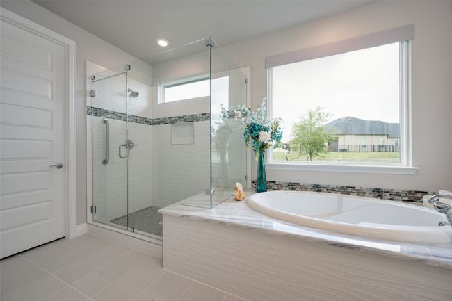 Primary Bathroom with separate shower and bath, Dolomite counter top and tile floor | Image 14