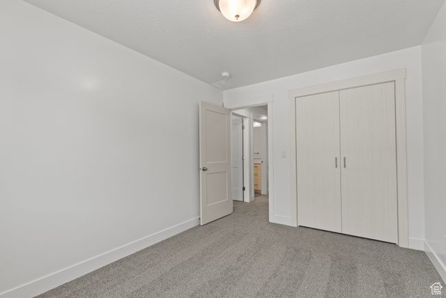 Unfurnished bedroom with carpet, a closet, and baseboards | Image 14