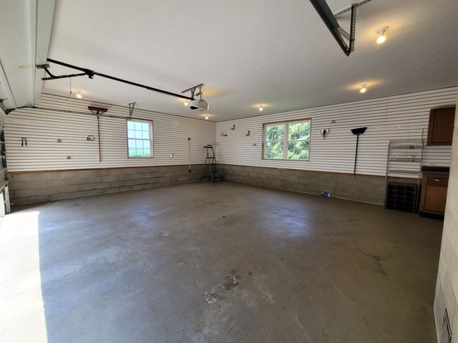 Large garage with counter space and cabinets for work area. Room for storage. | Image 70