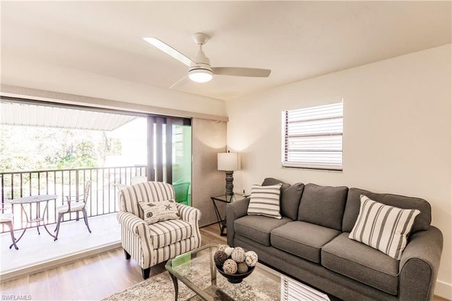 Living room featuring a ceiling fan and wood finished floors | Image 4