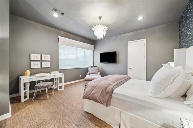 One of three upstairs Guest Bedrooms - #4 Bedroom (18 X 15) includes grass cloth flooring, base molding, painted walls, one papered accent wall, recessed lighting, central frosted glass chandelier, window with Roman shade and En Suite Bath. | Image 29