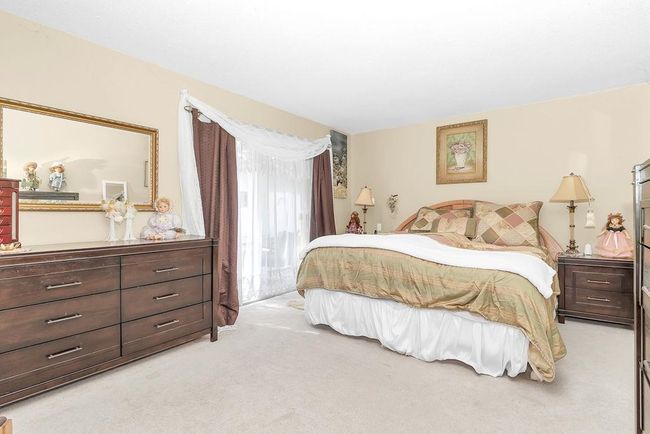 Bedroom featuring light colored carpet | Image 16