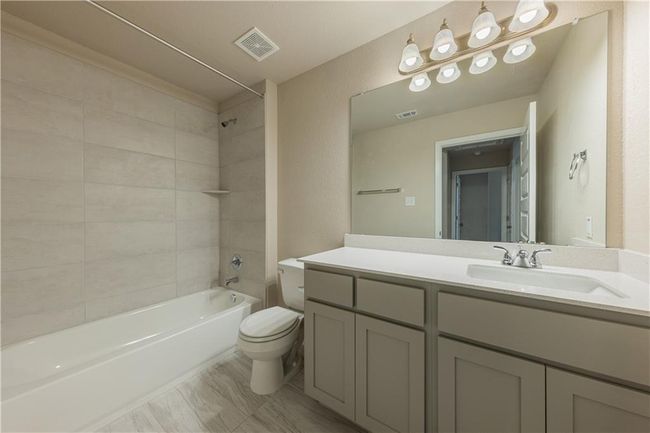 Full bathroom featuring toilet, shower / bath combination, and vanity | Image 14