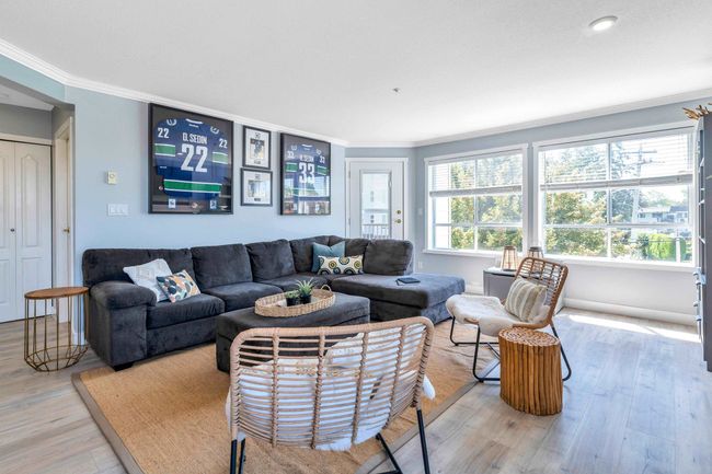 Living room featuring baseboards, wood finished floors, and ornamental molding | Image 8