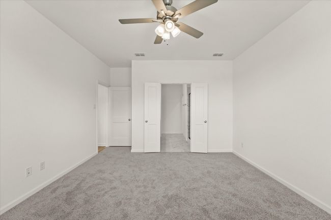 Unfurnished bedroom featuring carpet and ceiling fan | Image 7
