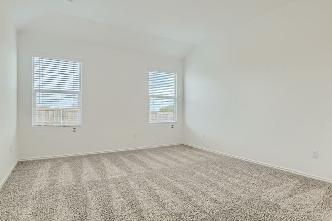 Empty room with vaulted ceiling, carpet, and baseboards | Image 10