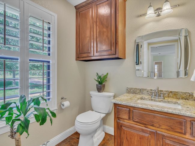 Bathroom featuring toilet, vanity, baseboards, and tile patterned floors | Image 16