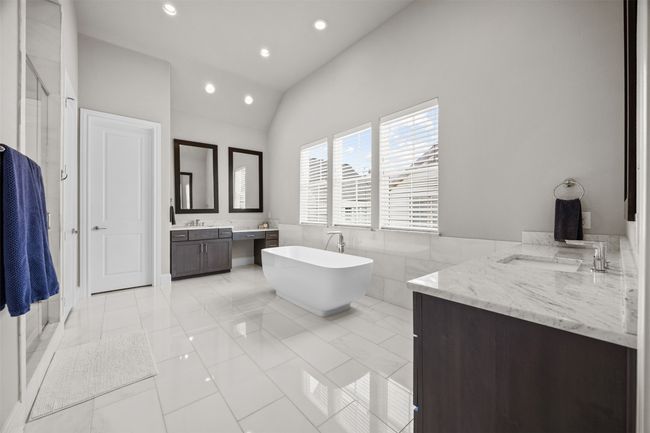Full bath with two vanities, recessed lighting, a freestanding bath, vaulted ceiling, and a shower stall | Image 19