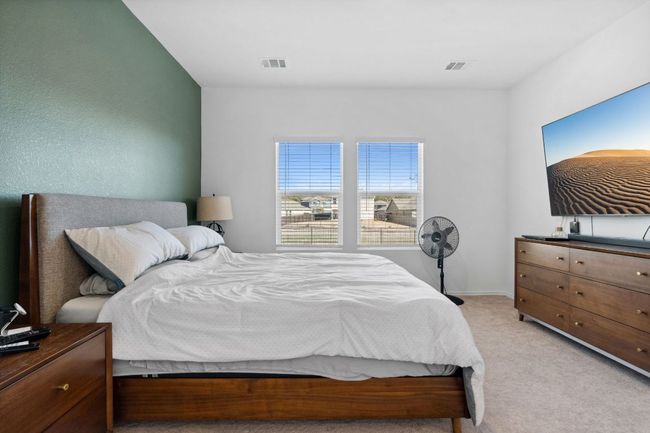 Bedroom featuring light colored carpet and visible vents | Image 17