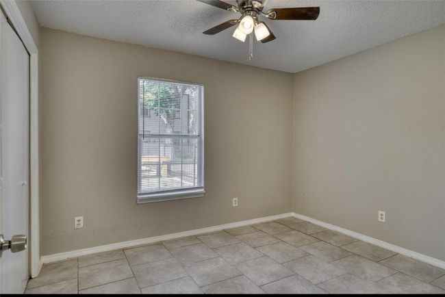 Unfurnished room featuring a textured ceiling, ceiling fan, and light tile patterned floors | Image 20