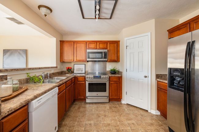 Half bath is located off the kitchen | Image 9