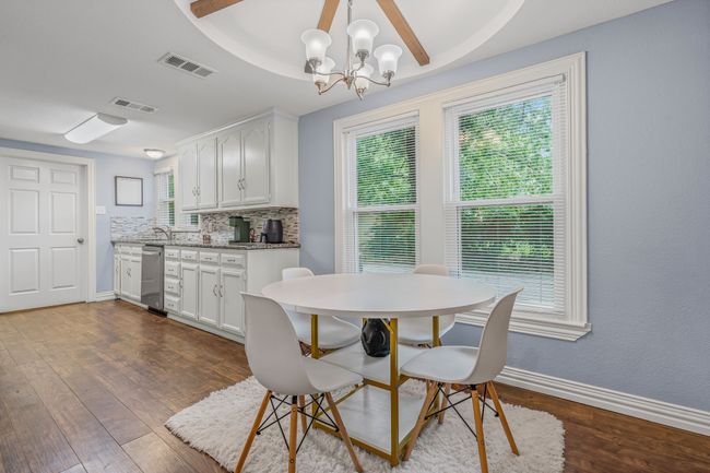 Dining room featuring dark wood finished floors and a chandelier | Image 9