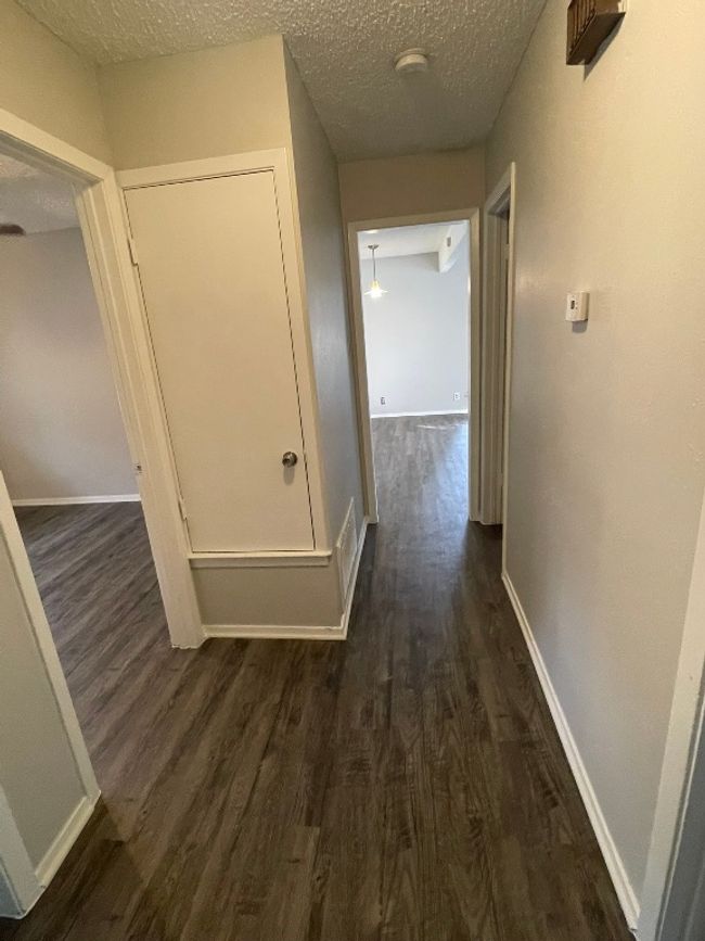 Corridor with dark wood finished floors and a textured ceiling | Image 14
